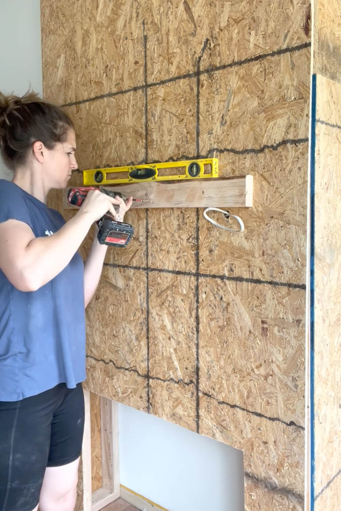 Installing a fireplace mantel.